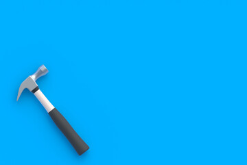 Hammer in the corner on blue background. Construction concept. Home renovation. Tools for repair. Top view. Copy space. 3d render