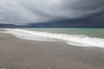 Storm clouds over the sea, waves on the beach, seascape