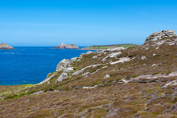Fototapeta na wymiar Tresco, Isles of Scilly, UK: the off-islands of St. Helens, Men-a-Vaur and Round Island with its conspicuous lighthouse, from Tregarthen Hill