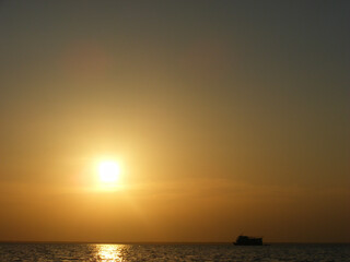 Naklejka na ściany i meble sunset over the Amazon River Brazil boat