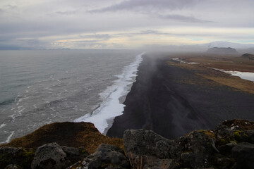 View to endless ocean black volcanic sand beach from Dyrholaey Cape Viewpoint, Vik, South Iceland