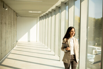 Young businesswoman walking on modern office hallway