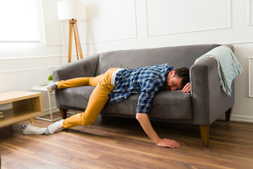 Caucasian man looking tired sleeping on the couch