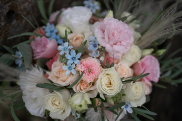 Wedding bouquet of white and pink flowers - roses, freesia, lisianthus, oxypetalum. Bride and groom.