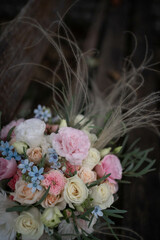 Wedding bouquet of white and pink flowers - roses, freesia, lisianthus, oxypetalum. Bride and groom.