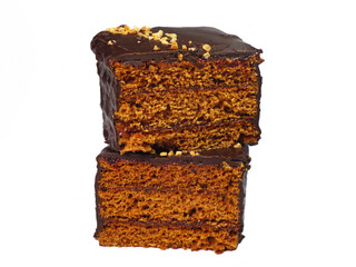 A ginger bread cake slice with plum jam filling cut in half stacked studio shot isolated on white background