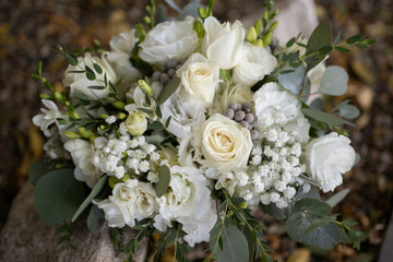 Wedding bouquet of white flowers - ranunculus, freesia, lisianthus.. Wedding. Bride and groom.