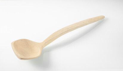 Wooden kitchen utensils.Wooden ladle for soup on a white background