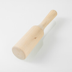 Wooden kitchen utensils. Wooden pestle for puree on a white background