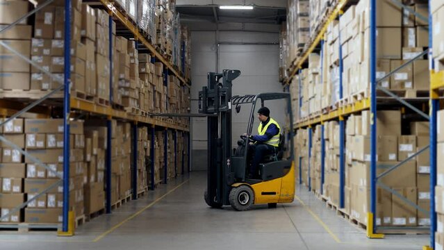 Warehouse worker using a fork lift.