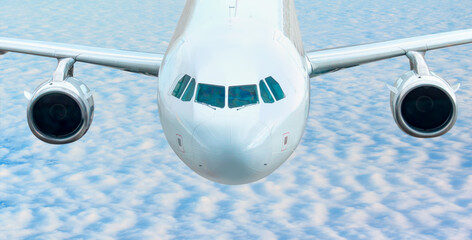 White passenger airplane flying in the sky amazing clouds in the background - Travel by air transport