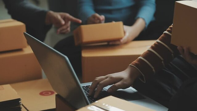 Entrepreneurs Small Business SME Independent men work at home Use smartphones and laptops for commercial checking, online marketing, packing boxes, SME sellers, concept, e-commerce team, online sales