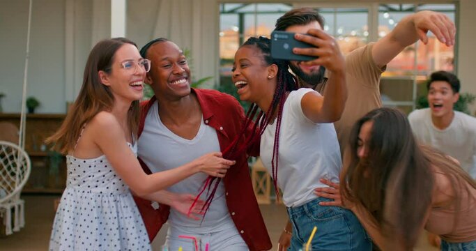 African American, Asian and Caucasian group of young people rushing to take selfie on picnic looking at camera and laughing having fun.crazy funny studnets have fun at picnic, outdoors, on fresh air