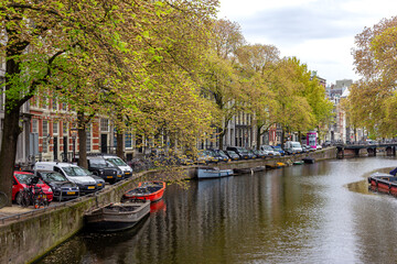 Fototapeta na wymiar Dutch houses and canals on the street of Amsterdam
