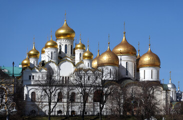 Assumption Cathedral and Annunciation Cathedral with golden cupolas in the Kremlin architecture ensemble view from embankment of the Moscow river