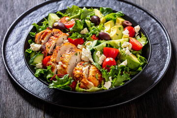 Mediterranean grilled Chicken Salad in black bowl