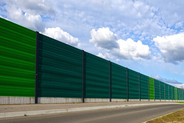 Fototapeta na wymiar Acoustic noise protection wall, also called noise fence barrier or road sound barrier for the protection from highway noise