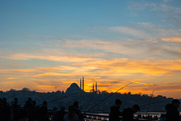 Silhouette of Suleymaniye Mosque and fishermen on the Galata Bridge