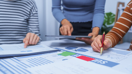 small business accounting team meeting three asian people with salary monthly charts data, basic business accounting and bookkeeping concept.