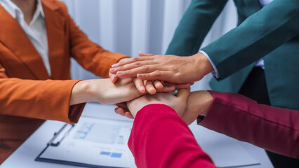 Fototapeta premium join hands teamwork concept. small business accounting team meeting three asian people with salary monthly charts data, basic business accounting and bookkeeping concept.