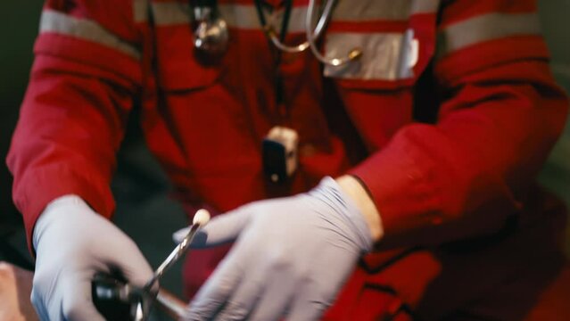 An EMS paramedic team provides medical care to an injured patient on their way to the hospital. Emergency room assistants perform resuscitation to bring a man back to life in an ambulance.