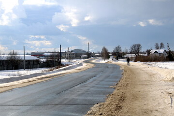 Highway passing through the village in early spring on a sunny day.