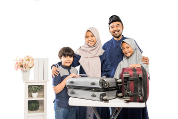 portrait of muslim asian family with suitcase going for eid mubarak holiday