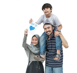 Fototapeta premium portrait of happy dad carry his son on a shoulder holding a love card for father's day