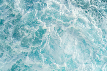 Rough deep turquoise and blue Red sea with white foam texture background