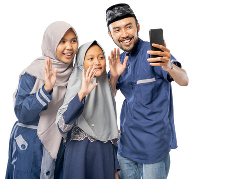happy muslim family wave to their phone while making a video call and selfie