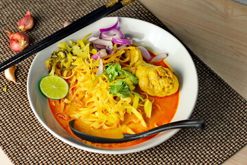 Khao soy Recipe, Curried Noodle Soup with Chicken Served on white Bowl, Thai Food, Curry Noodle, Thai Noodle, Northern Food.