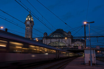 Train driving past Gare des Benedictins at dusk, Limoges, Winter, France