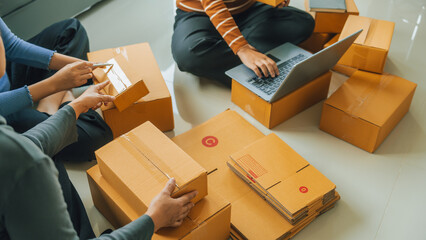 SMEs small business owner parcel delivery, A family of mothers and daughters helped each other to pack products into boxes.