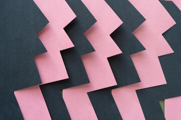 Fototapeta na wymiar abstract shapes made of pink and black construction paper - graphic representation of a burst
