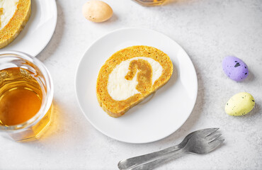 Easter caroot roll cake with cream cheese filling in a plate