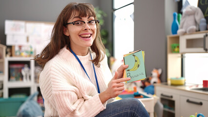 Young caucasian woman teaching words at kindergarten