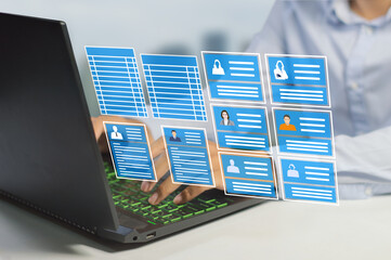 HR officer working on a laptop with employee data to manage payroll, holiday leave and recruit more...