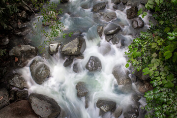Water flowing rapidly in a stream along the Kinabalu Park in Poring Hot Spring, Sabah, Malaysia
