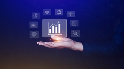 Big data analytics and business intelligence BI concept with chart and graph icons on digital screen interface and business people in the background.