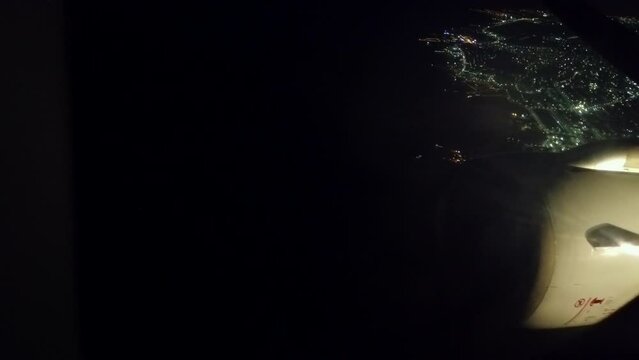 Take off from Hurghada airport at night. Pov from passenger window with view of wing and engine