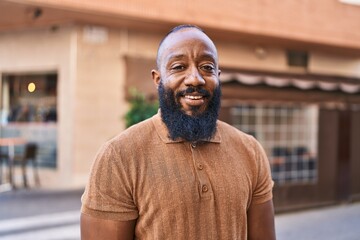 Young african american man smiling confident standing at street