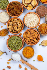 Healthy vegetarian food concept. Assortment of dried fruits, nuts and seeds on white background. Top view.