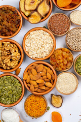Healthy vegetarian food concept. Assortment of dried fruits, nuts and seeds on white background. Top view.