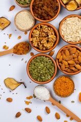 Healthy vegetarian food concept. Assortment of dried fruits, nuts and seeds on white background. Top view.