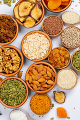 Healthy vegetarian food concept. Assortment of dried fruits, nuts and seeds on white background. Top view. Mixed nuts set closeup.