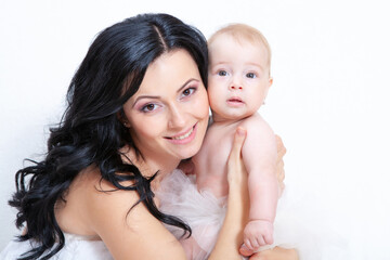 happy mother with baby on a light background