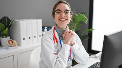 Young caucasian woman doctor using computer working at clinic