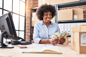 African american woman ecommerce business worker counting dollars at office