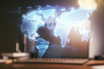 Abstract creative world map on modern laptop background, international trading concept. Multiexposure