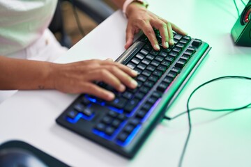 Young beautiful hispanic woman using computer keyboard at street
